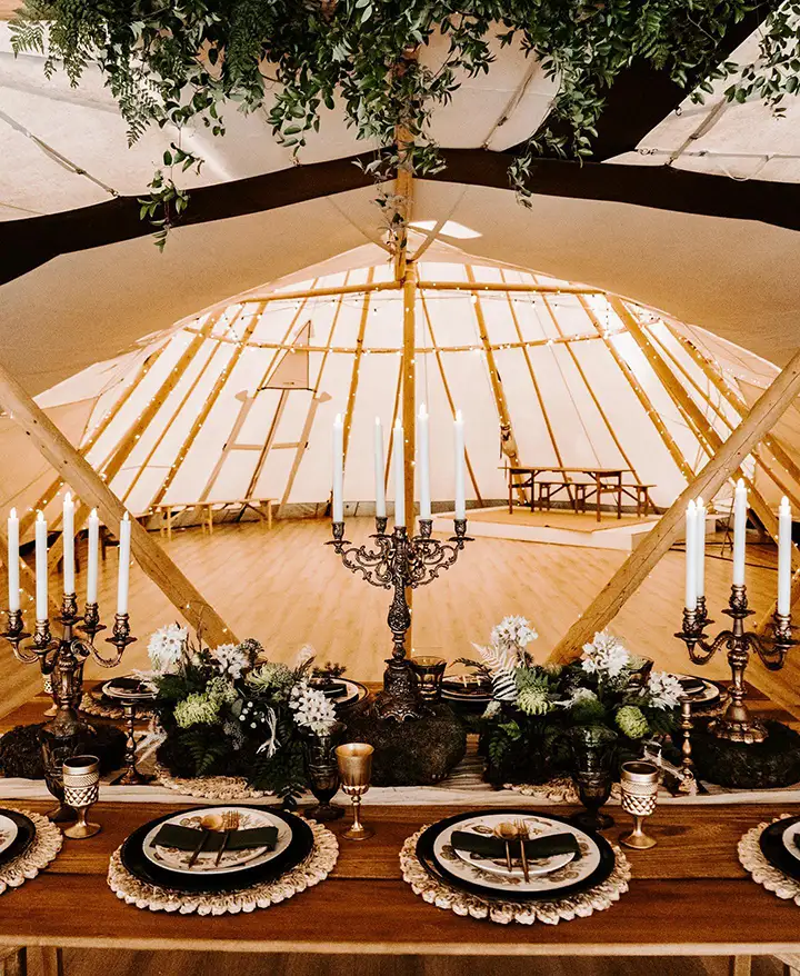 A rustic tepee tent serving as a unique table setup at wedding venues in Texas.