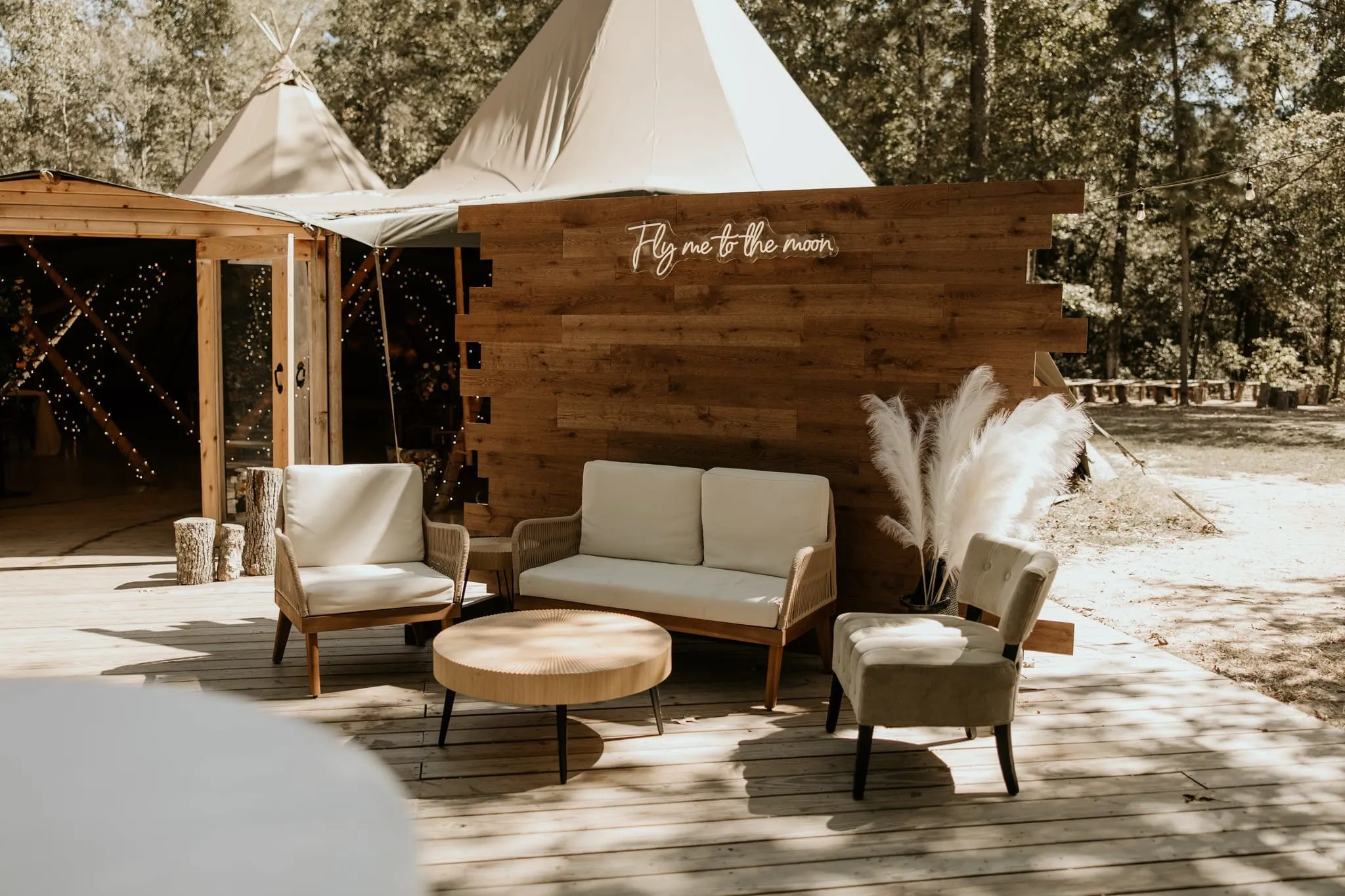 &ldquo;Wedding reception inside connected Nordic tipis with warm string lights, banquet tables, and buffet setup at The Shire Tipis